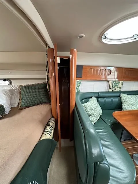 Slide: The Image of Interior of 2000 Four Winns 328 Vista boat with green seating and wood accents. - 26