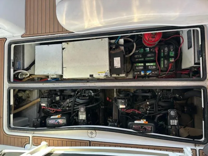Slide: The Image of Engine compartment of 2000 Four Winns 328 Vista boat, showing dual engines and battery setup. - 27