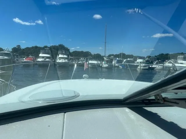 Slide: The Image of View from 2000 Four Winns 328 Vista boat in a marina with clear blue sky. - 13