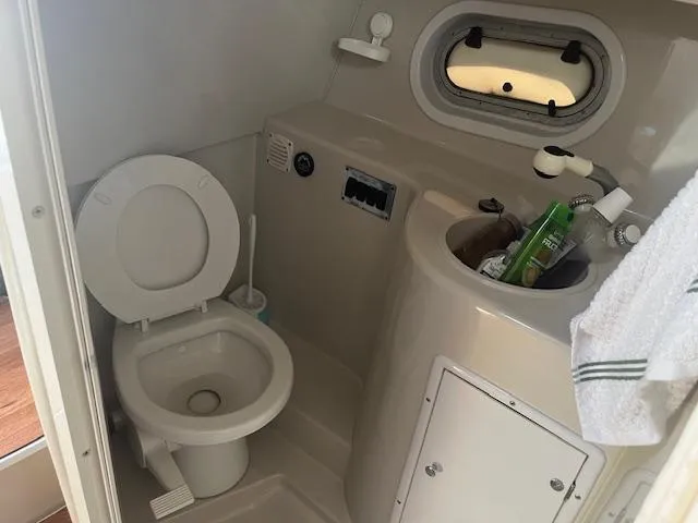 Slide: The Image of Bathroom in 2000 Four Winns 328 Vista boat with toilet and sink. - 19