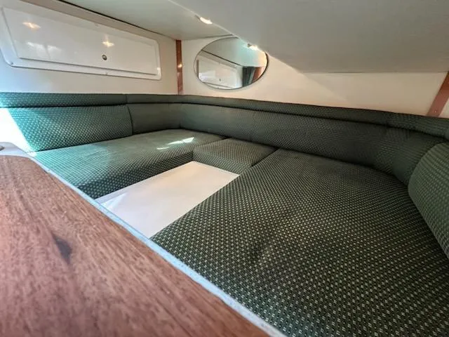 Slide: The Image of Interior cabin of 2000 Four Winns 328 Vista with green upholstery and wood accents. - 21