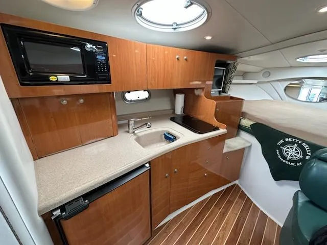 Slide: The Image of Interior of 2000 Four Winns 328 Vista boat with kitchenette and wood finish. - 17
