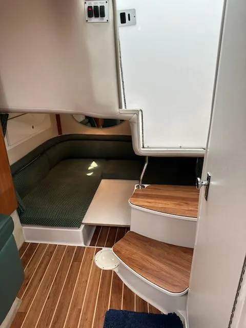 Slide: The Image of Interior of 2000 Four Winns 328 Vista boat with wooden steps and seating area. - 20