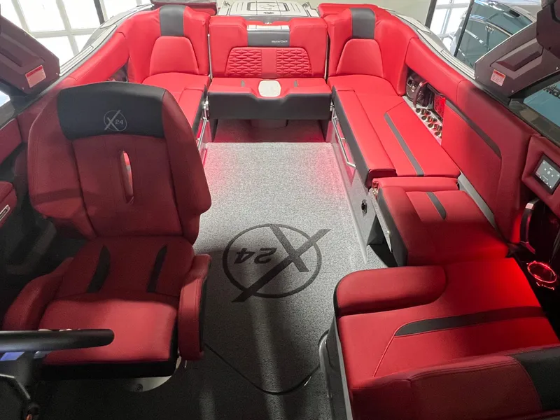 Slide: The Image of 2025 MasterCraft X24 boat interior with luxurious red seating and modern design. - 6
