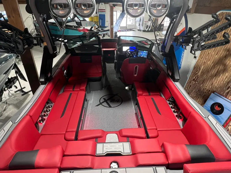 Slide: The Image of 2025 MasterCraft X24 boat interior with red seating and advanced audio system. - 7
