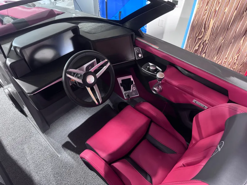 Slide: The Image of 2025 MasterCraft X24 boat interior with red seats and modern dashboard. - 8