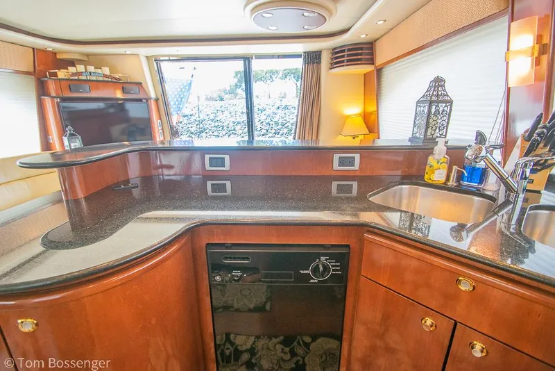 Slide: The Image of Luxurious 2008 Meridian 580 Pilothouse yacht interior with modern kitchen and elegant wood finishes. - 23