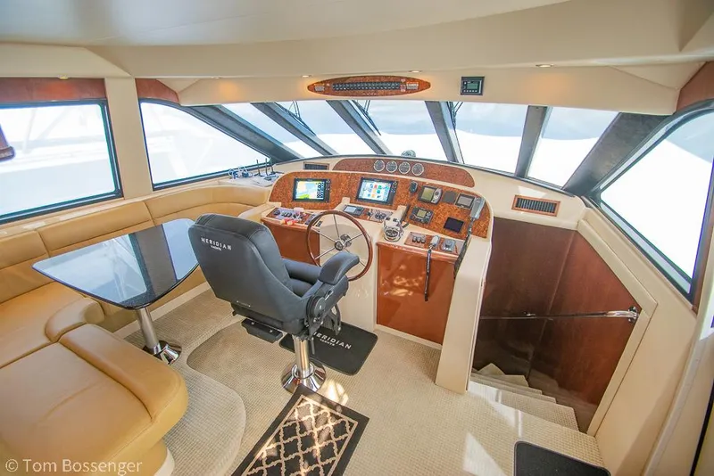 Slide: The Image of Luxurious 2008 Meridian 580 Pilothouse interior with helm, seating, and navigation equipment. - 29