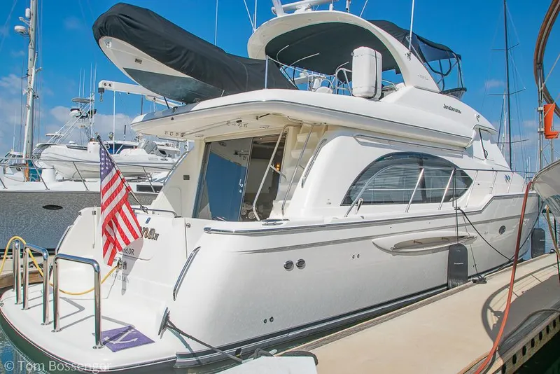 Slide: The Image of 2008 Meridian 580 Pilothouse yacht docked, featuring sleek design and American flag. - 3