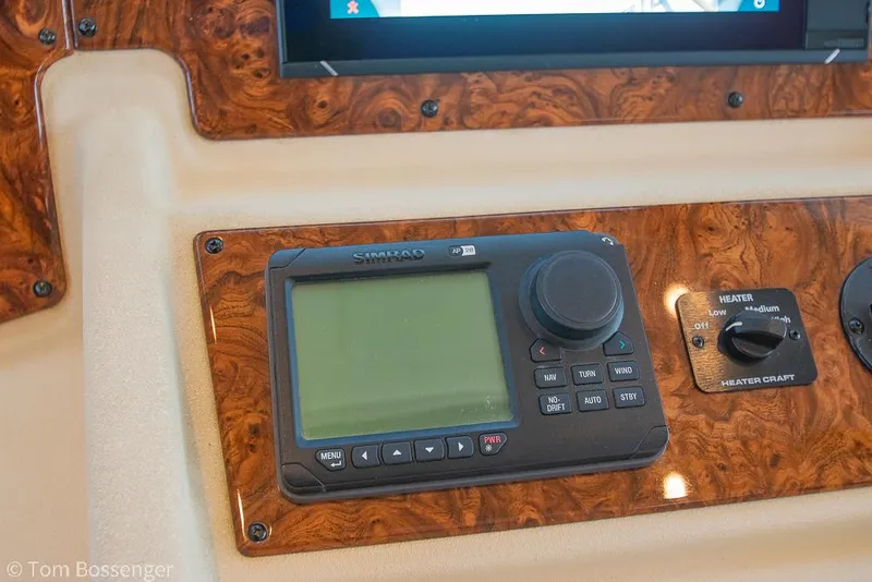 Slide: The Image of Control panel of 2008 Meridian 580 Pilothouse with navigation display and heater controls. - 36