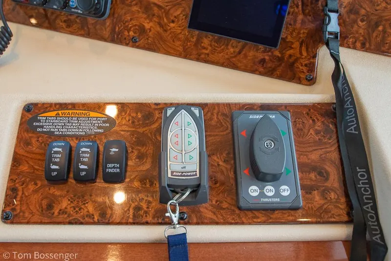 Slide: The Image of Control panel of a 2008 Meridian 580 Pilothouse with various switches and controls. - 37