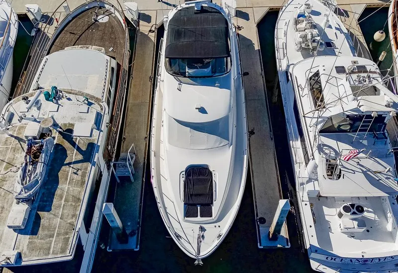 Slide: The Image of Aerial view of a 2008 Meridian 580 Pilothouse yacht docked between two boats. - 4