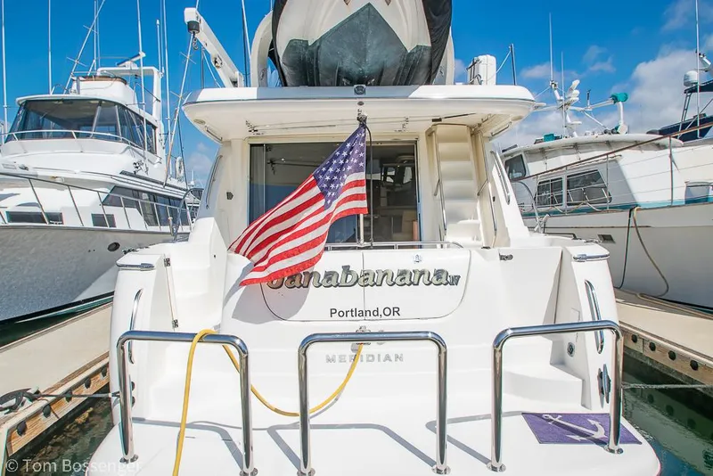 Slide: The Image of 2008 Meridian 580 Pilothouse yacht docked, displaying American flag, Portland, OR. - 7