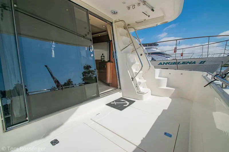 Slide: The Image of 2008 Meridian 580 Pilothouse yacht deck with stairs and glass door under blue sky. - 8
