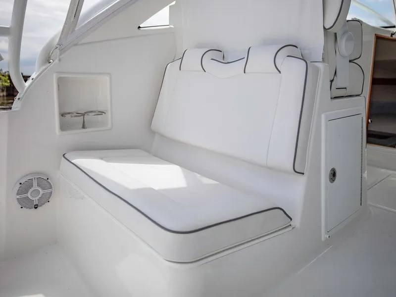 Slide: The Image of 2025 Albemarle 30 Express boat interior with white cushioned seating. - 9