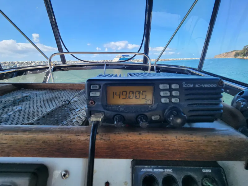 Slide: The Image of 1988 Chris-Craft 315 Commander cockpit with marine radio, ocean view. - 12