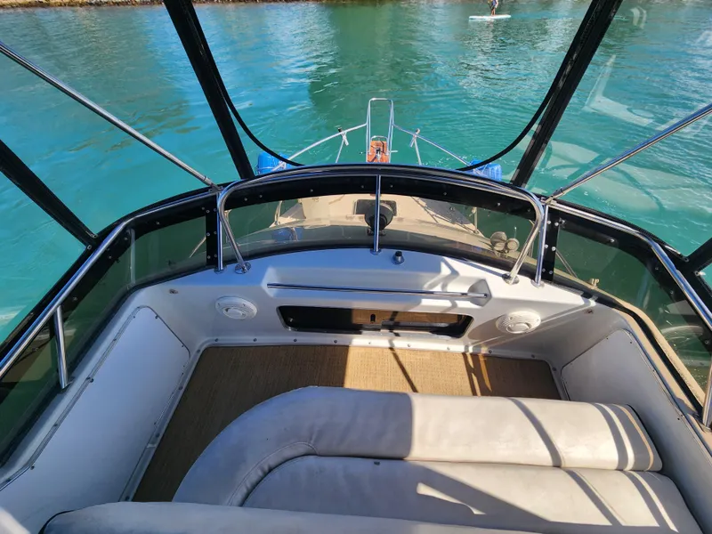 Slide: The Image of 1988 Chris-Craft 315 Commander boat interior with clear view of turquoise water. - 13