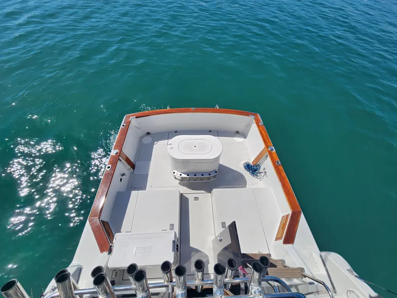 Slide: The Image of 1988 Chris-Craft 315 Commander boat deck on clear blue water. - 16