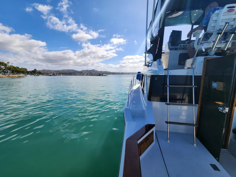 Slide: The Image of 1988 Chris-Craft 315 Commander on serene turquoise waters under a bright blue sky. - 20