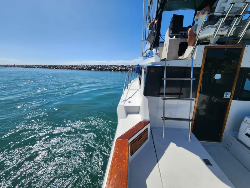 Slide: The Image of 1988 Chris-Craft 315 Commander boat on calm water, sunny day, side view. - 22