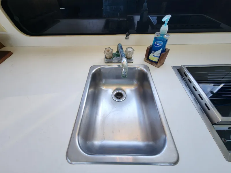 Slide: The Image of Stainless steel sink on 1988 Chris-Craft 315 Commander boat with faucet and soap dispenser. - 27