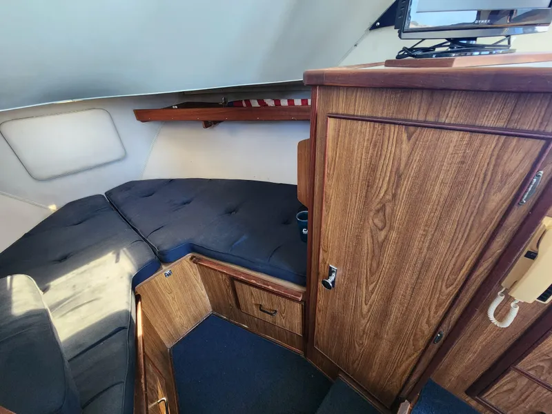 Slide: The Image of 1988 Chris-Craft 315 Commander cabin interior with wood cabinetry and cushioned seating. - 36