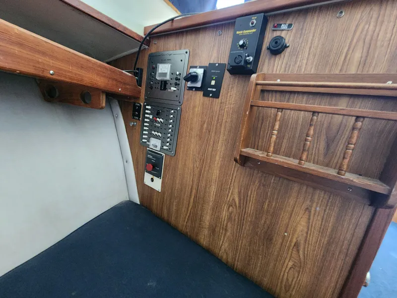 Slide: The Image of 1988 Chris-Craft 315 Commander cabin interior with control panel and wood finish. - 37