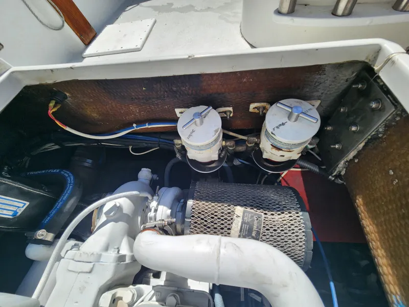 Slide: The Image of Engine compartment of 1988 Chris-Craft 315 Commander with visible filters and wiring. - 43
