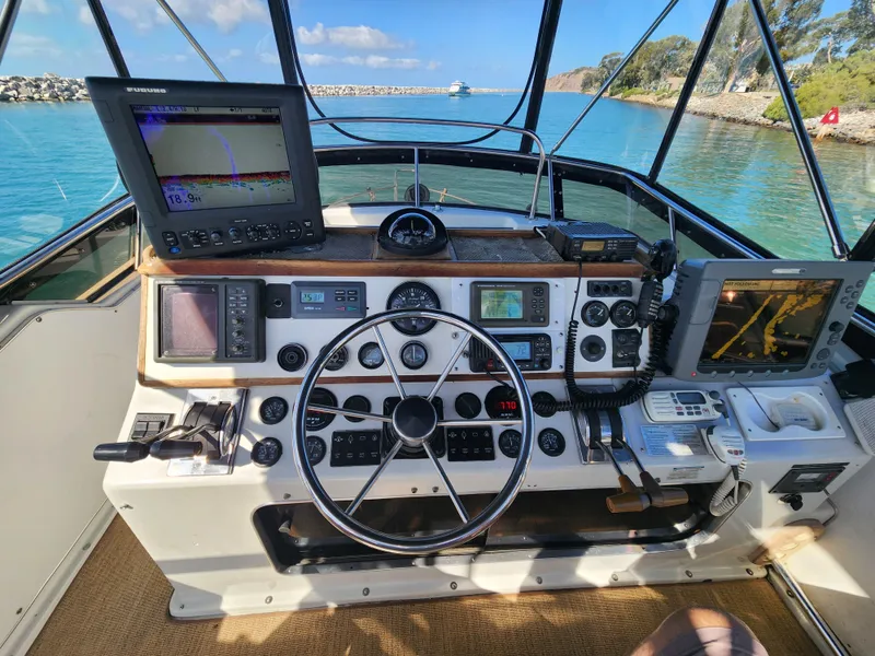 Slide: The Image of Helm of 1988 Chris-Craft 315 Commander with navigation equipment and steering wheel. - 7