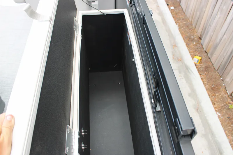 Slide: The Image of Open storage compartment of 2025 Starcraft EXS 3 Q DH boat. - 13