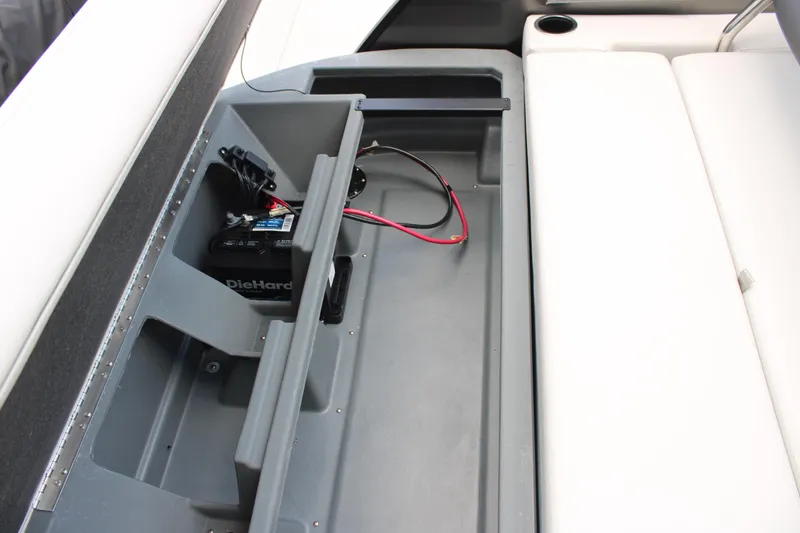 Slide: The Image of Starcraft EXS 3 Q DH 2025 boat storage compartment with battery and wiring. - 15