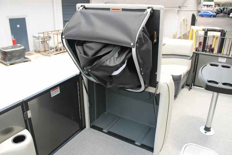 Slide: The Image of Starcraft EXS 3 Q DH 2025 boat interior with storage compartment and seating area. - 16