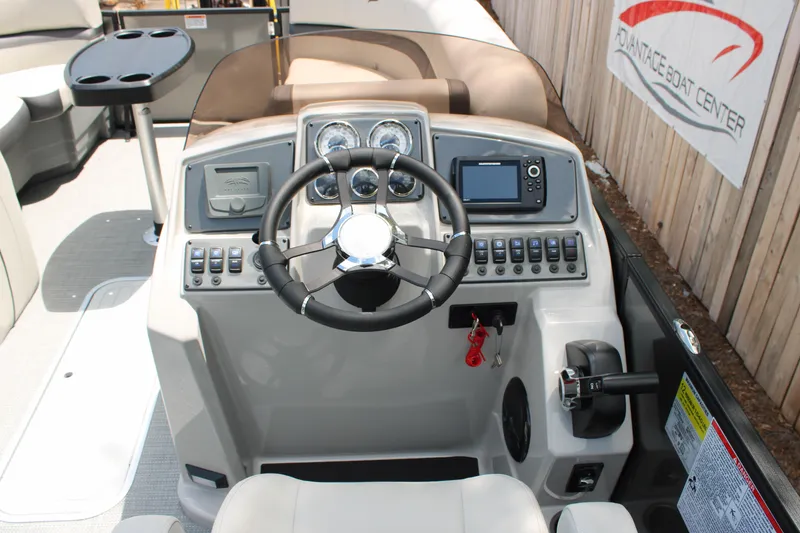 Slide: The Image of 2025 Starcraft EXS 3 Q DH boat dashboard with steering wheel and controls. - 8