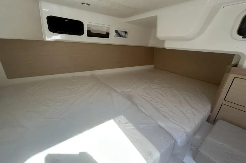 Slide: The Image of Interior cabin of 2025 Parker Poland Sorrento 100 boat, featuring a spacious bed. - 26