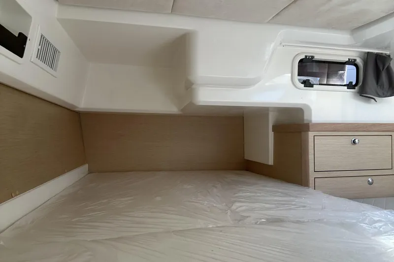 Slide: The Image of Interior cabin of 2025 Parker Poland Sorrento 100 boat, featuring bed and storage drawers. - 27