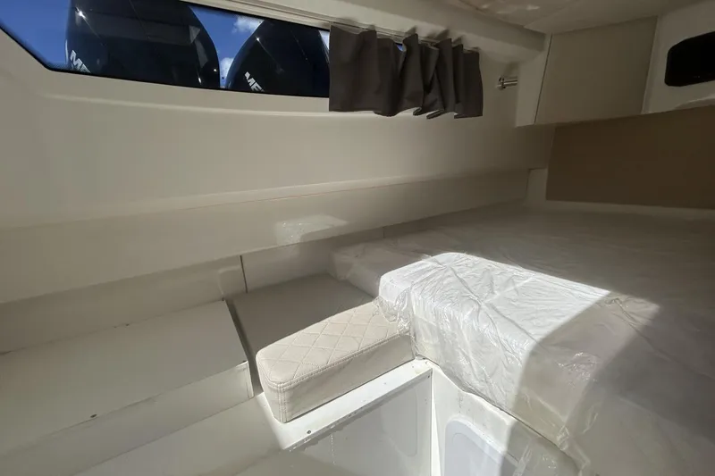 Slide: The Image of Interior cabin of 2025 Parker Poland Sorrento 100 boat, featuring a bed and window. - 29