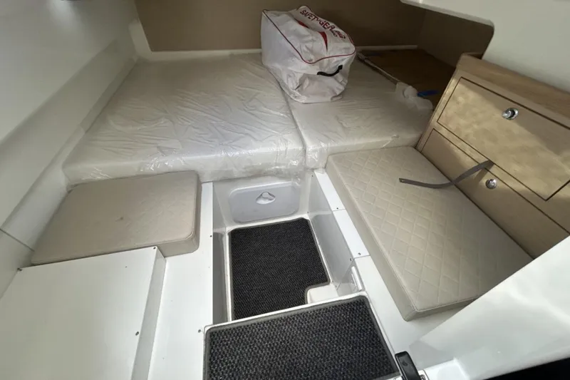 Slide: The Image of 2025 Parker Poland Sorrento 100 cabin interior with cushioned seating and storage. - 33