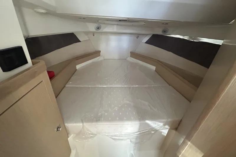 Slide: The Image of Interior cabin of 2025 Parker Poland Sorrento 100 boat, featuring a cozy sleeping area. - 36