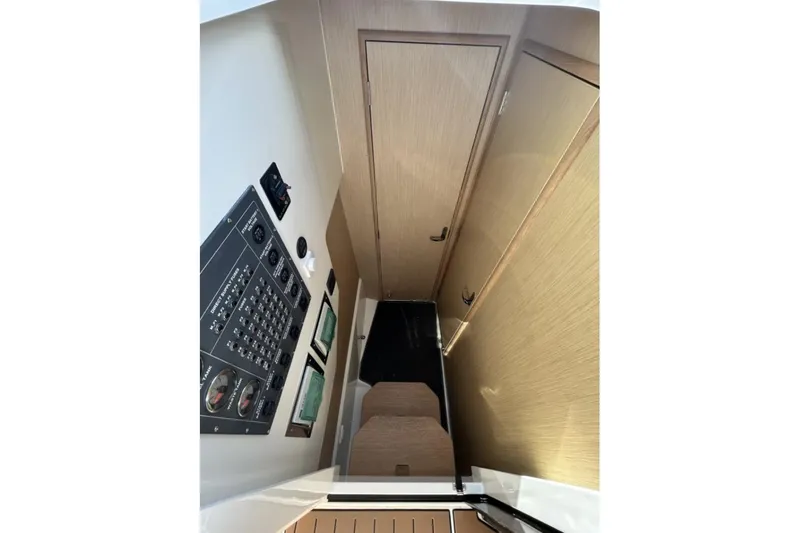 Slide: The Image of Interior of 2025 Parker Poland Sorrento 100 boat, featuring control panel and wooden cabinetry. - 39