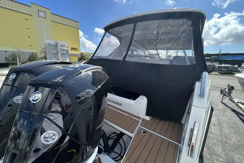 Slide: The Image of 2025 Parker Poland Sorrento 100 boat with dual engines and covered cockpit, docked outdoors. - 41