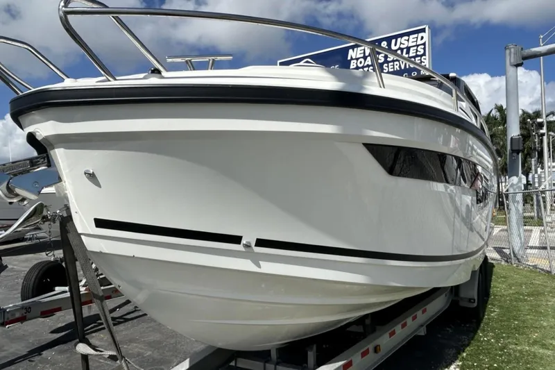 Slide: The Image of 2025 Parker Poland Sorrento 100 boat on trailer under blue sky. - 42