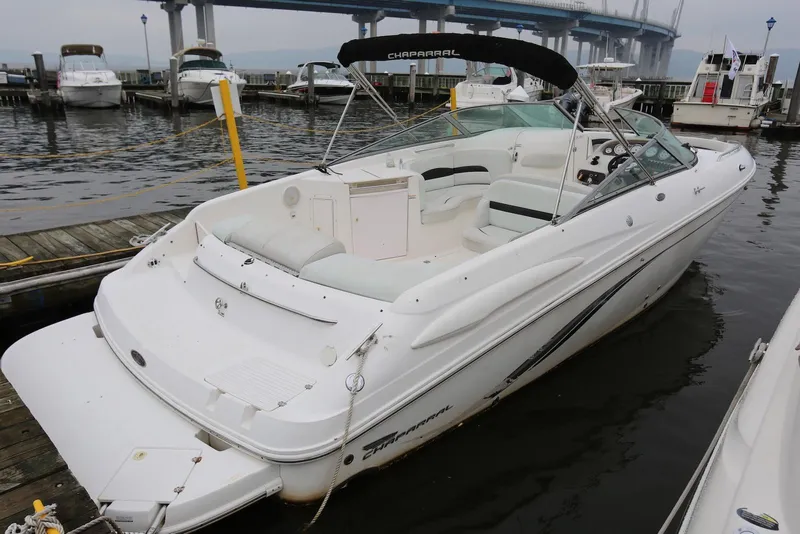 The Image of 2002 Chaparral 280 SSi boat docked at marina with bridge in background. - 0