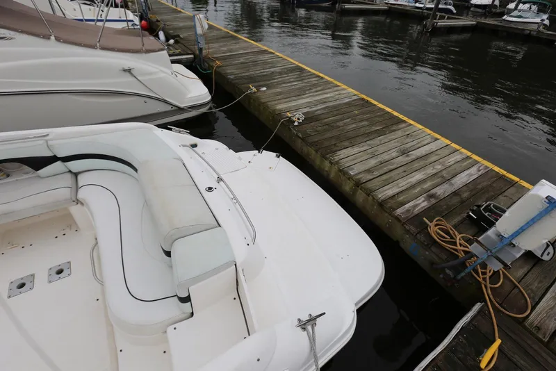 Slide: The Image of 2002 Chaparral 280 SSi boat docked at a marina with wooden pier. - 10