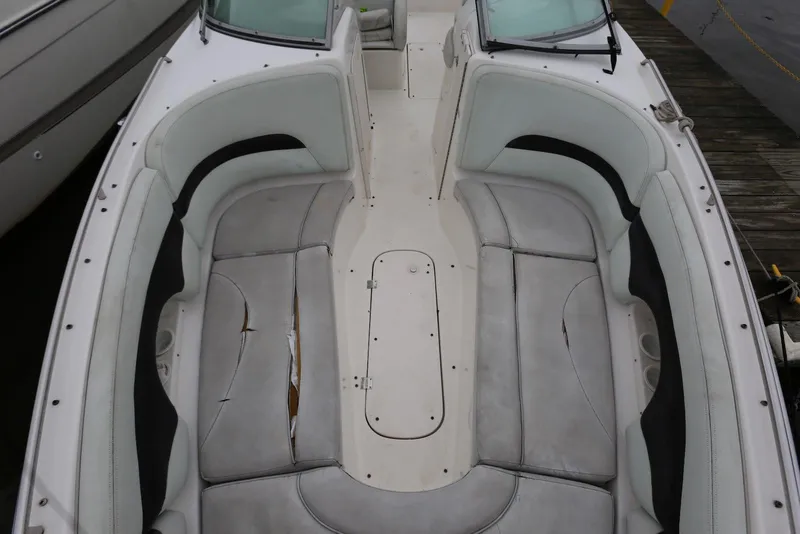 Slide: The Image of 2002 Chaparral 280 SSi boat interior with worn seating and spacious layout. - 15