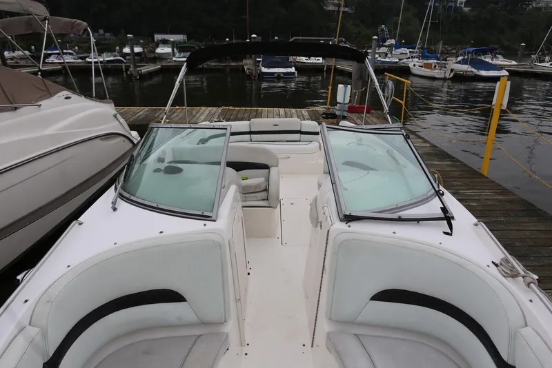 Slide: The Image of 2002 Chaparral 280 SSi boat docked at marina, featuring spacious seating and sleek design. - 16