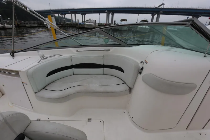 Slide: The Image of 2002 Chaparral 280 SSi boat interior with white seating and waterfront view. - 18
