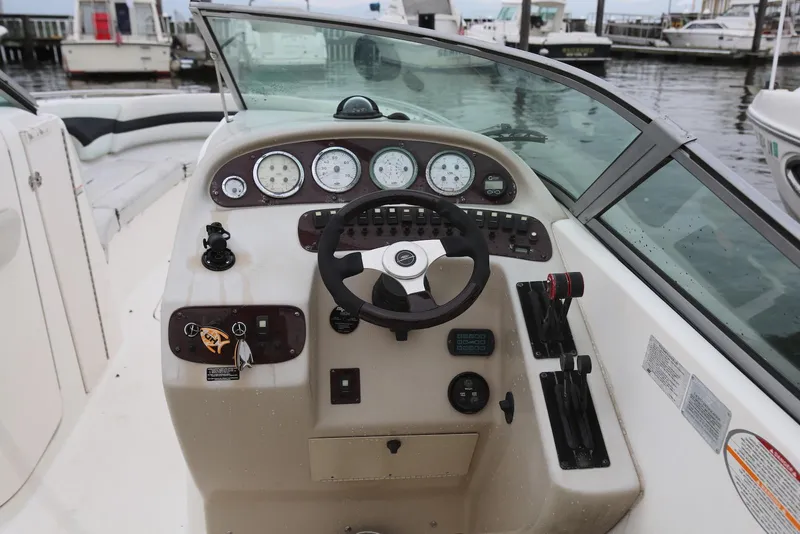 Slide: The Image of 2002 Chaparral 280 SSi boat dashboard with steering wheel and gauges at marina. - 20