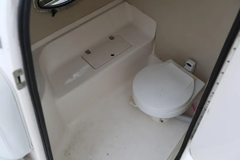 Slide: The Image of Interior of 2002 Chaparral 280 SSi boat showing compact marine toilet. - 23