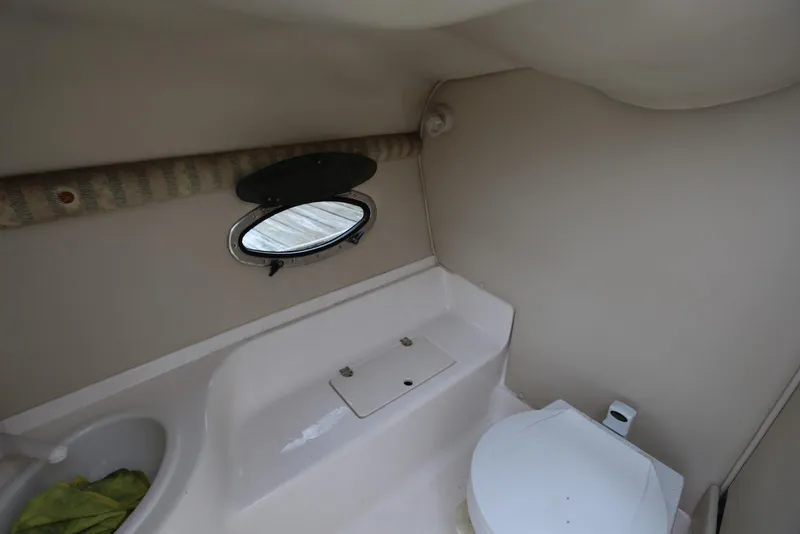 Slide: The Image of Interior of 2002 Chaparral 280 SSi boat bathroom with sink and toilet. - 26