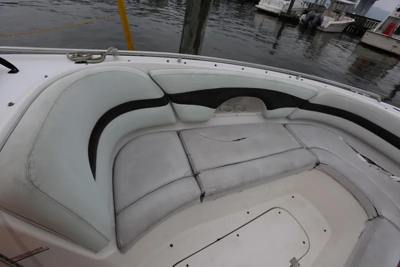 Slide: The Image of 2002 Chaparral 280 SSi boat interior with white and black seating by the water. - 28